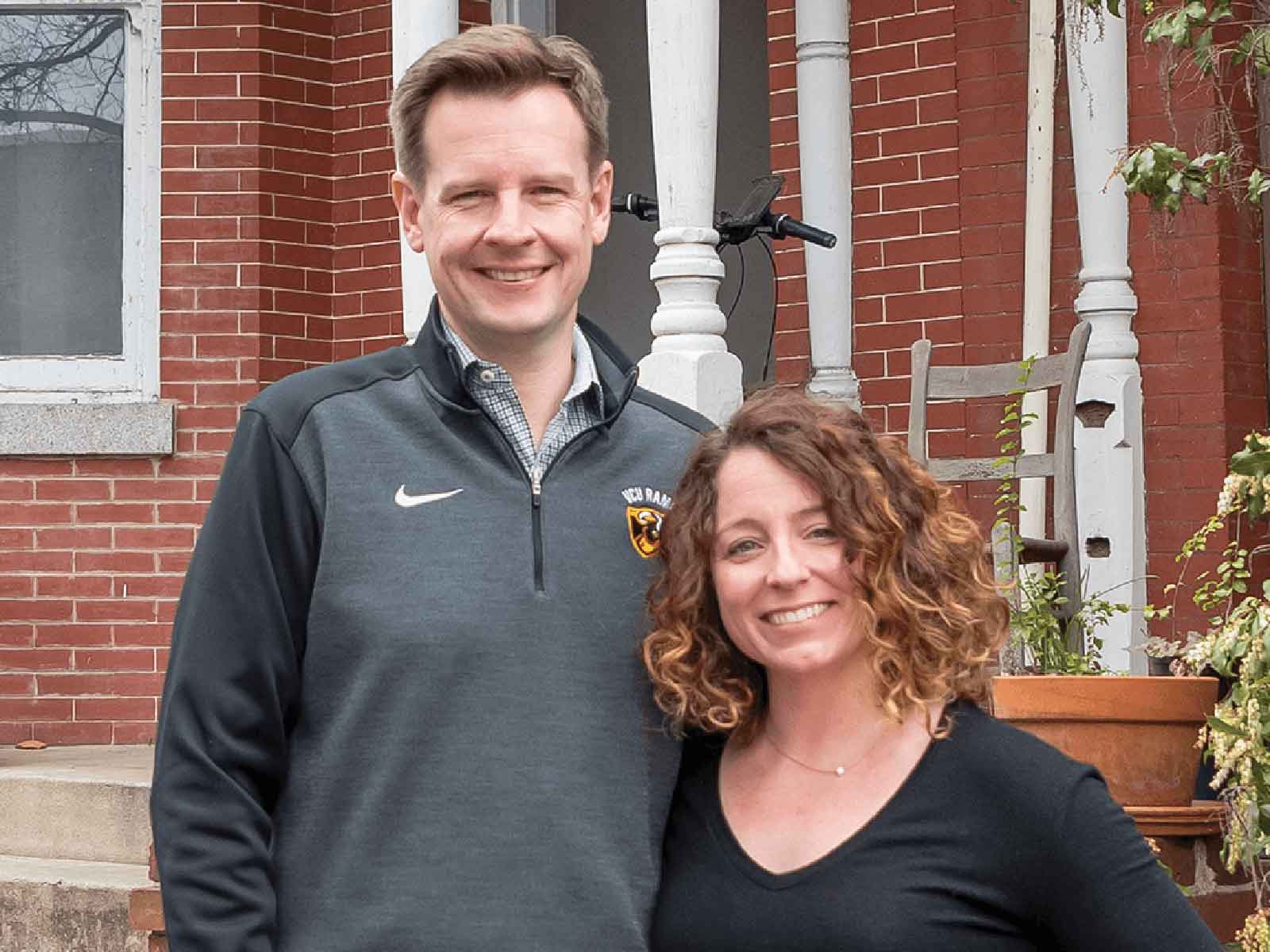 Brian and Jessica Haug standing outside their first house in Richmond’s historic Fan district